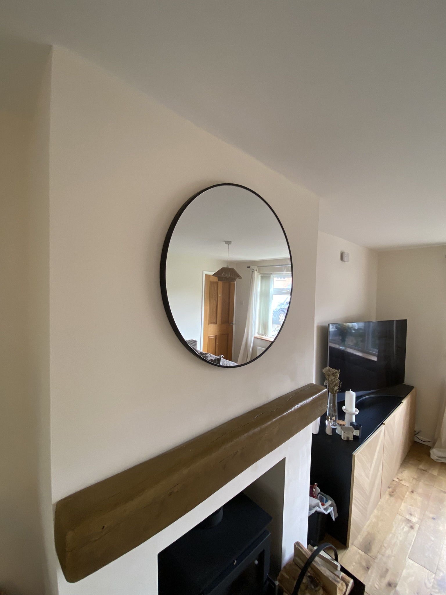 Round Mirror Above Fireplace